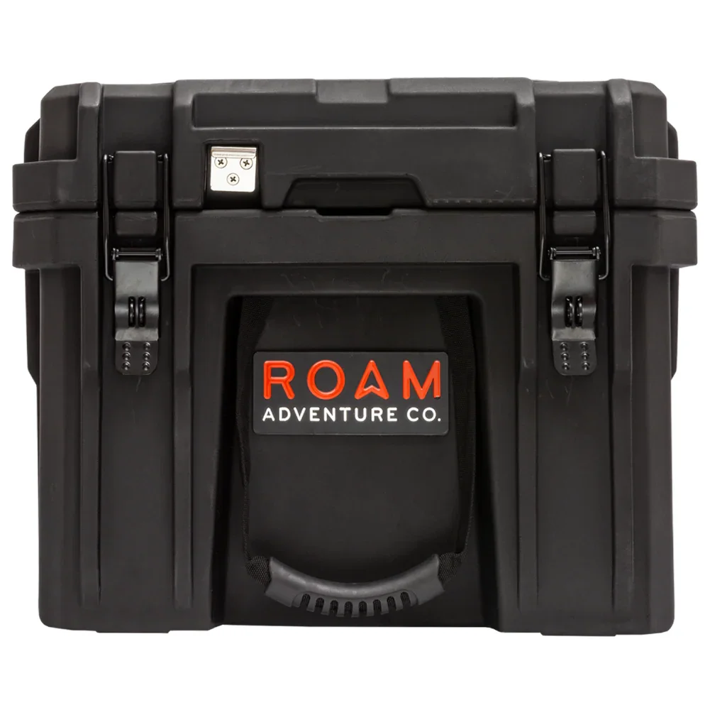 Black overland storage box with front handle and ROAM Adventure Co. logo for camping gear