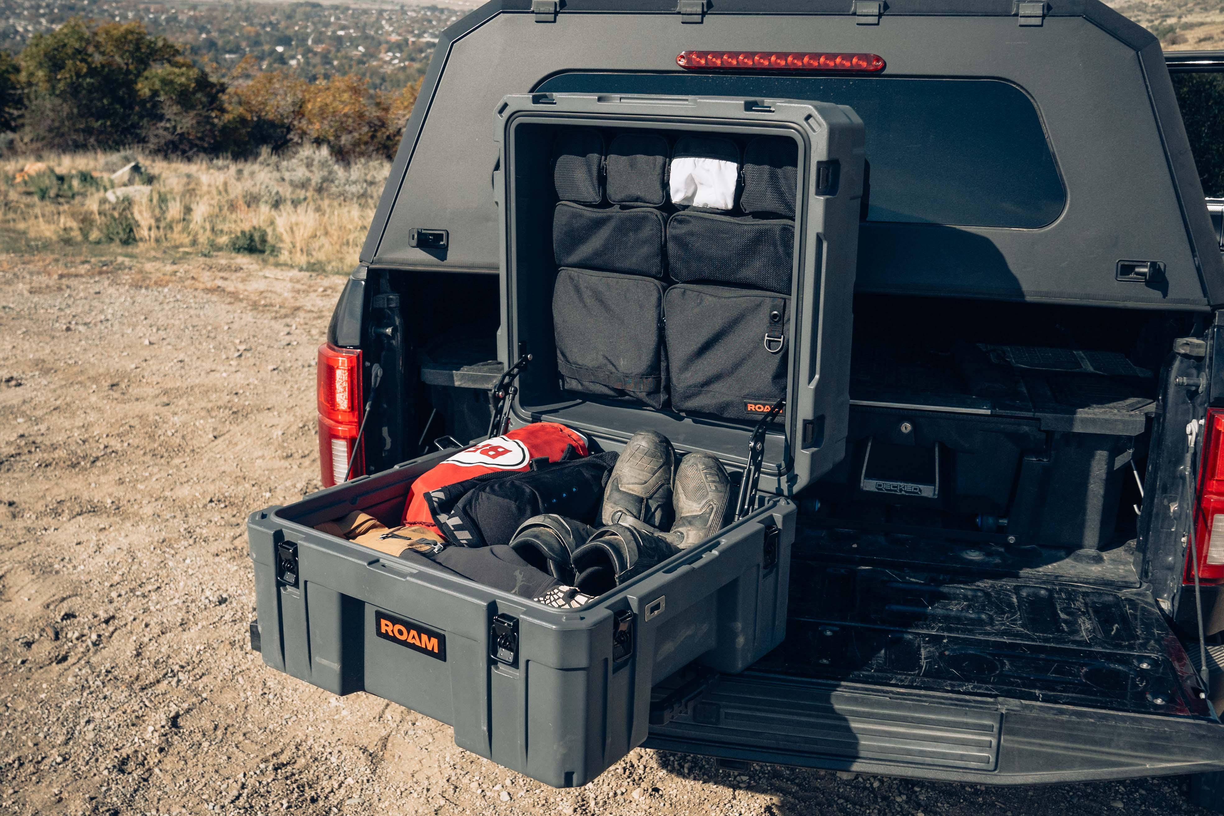 Overlanding storage box with organized camping gear on truck bed outdoors