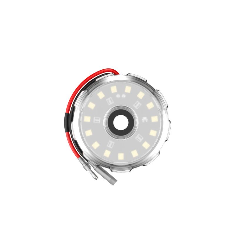 Round LED accessory light with clear lens and red wiring for off-road or overlanding vehicles