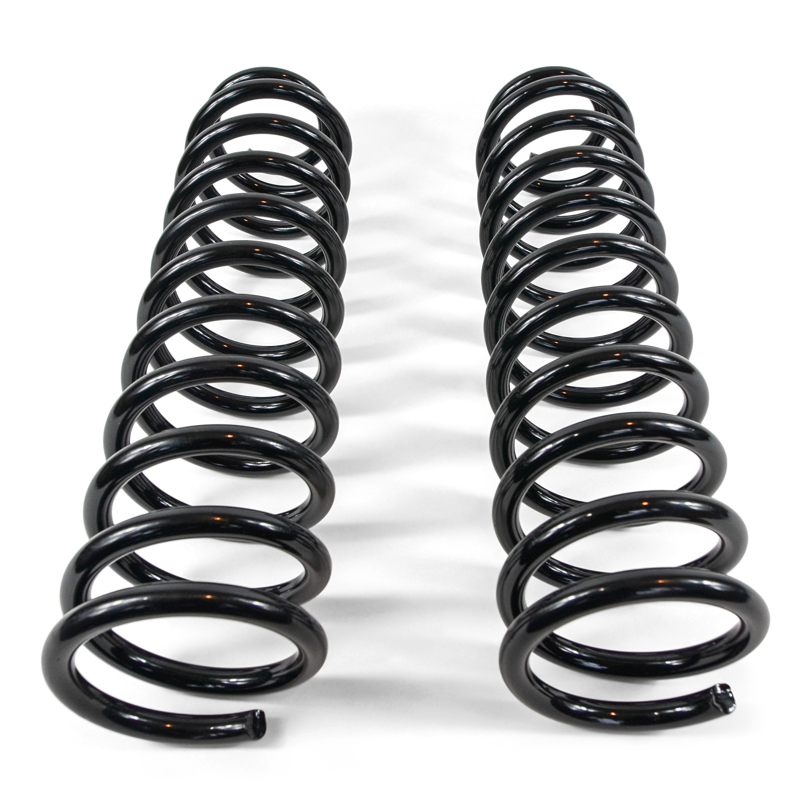Black heavy-duty coil springs for off-road vehicle suspension on white background