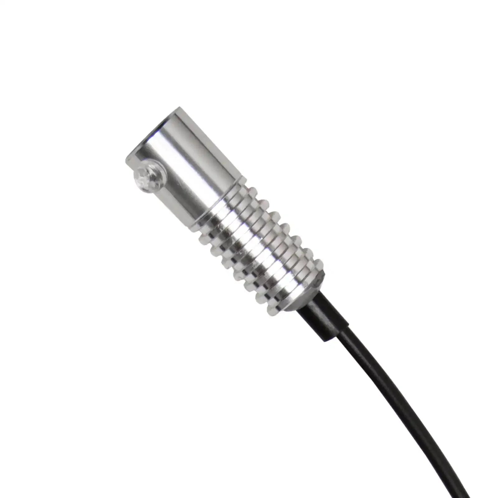 Close-up of a silver LED rock light with black wiring for off-road vehicles and overlanding.