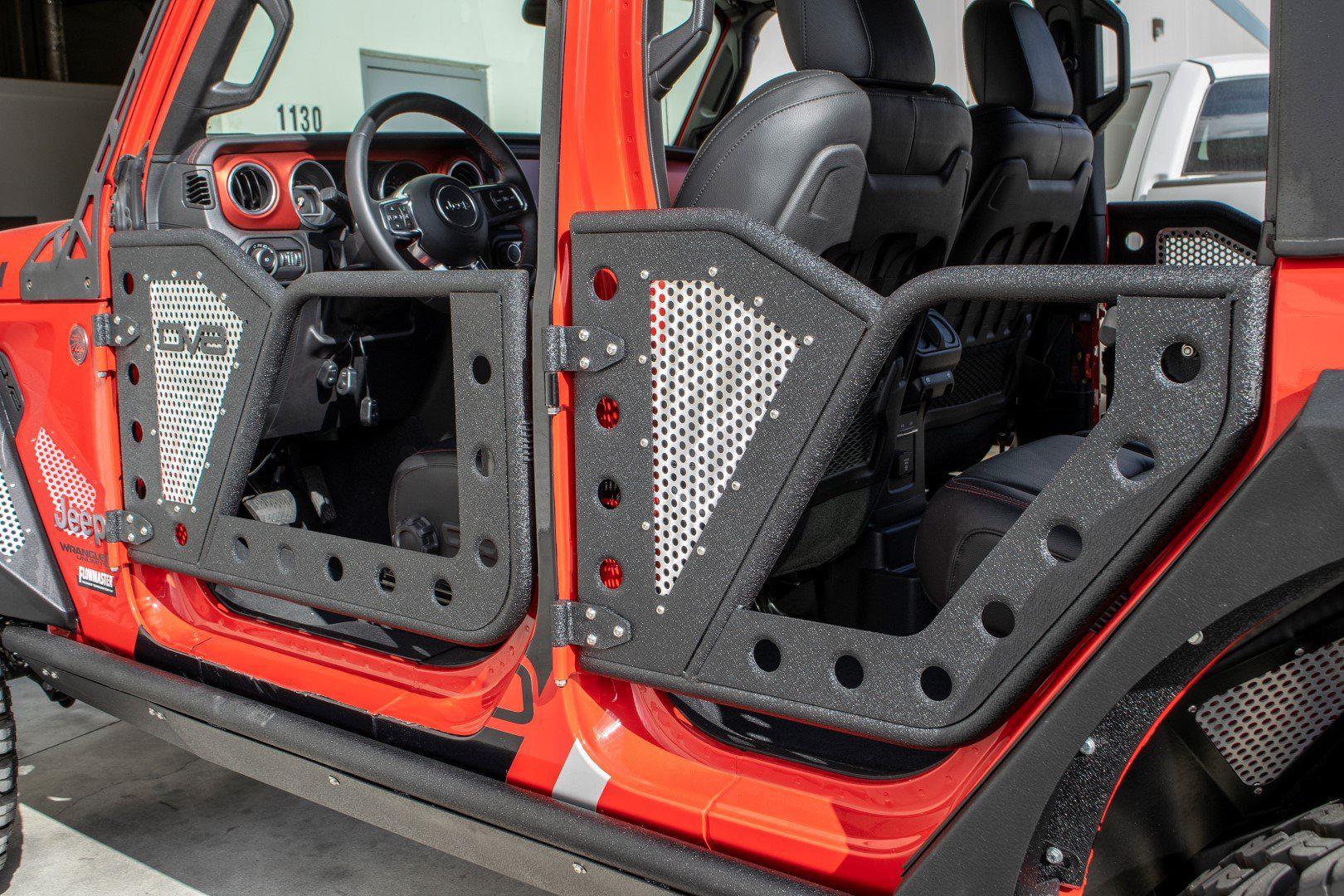Jeep Wrangler with DV8 Offroad rock doors, exposed rugged metal design, black mesh panels