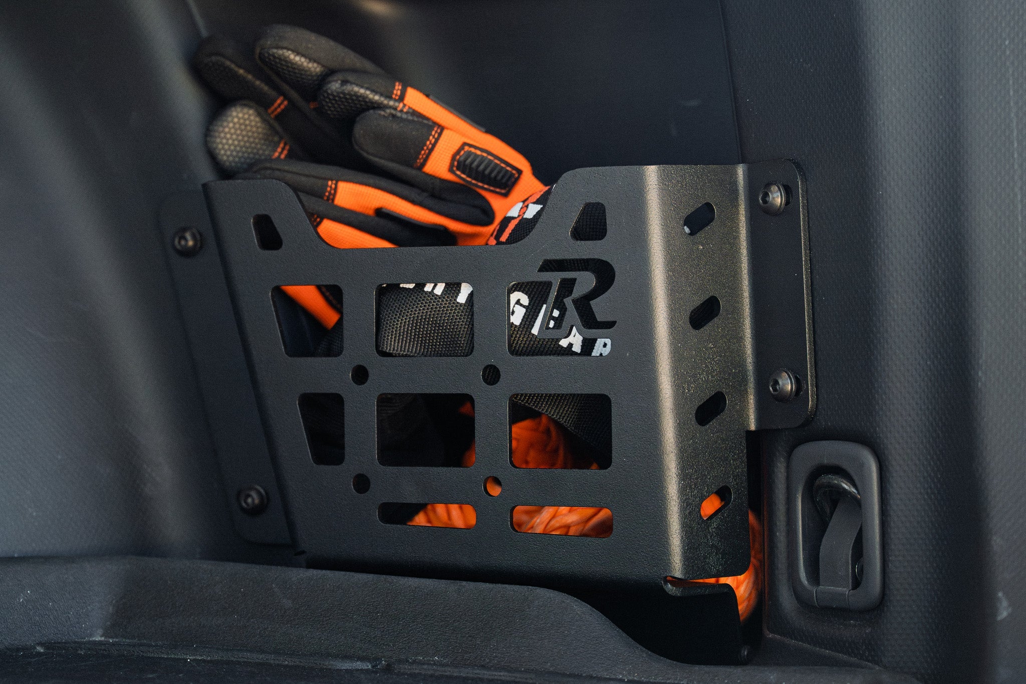 Subaru Forester rear cargo pocket molle panel with orange gloves for overlanding storage