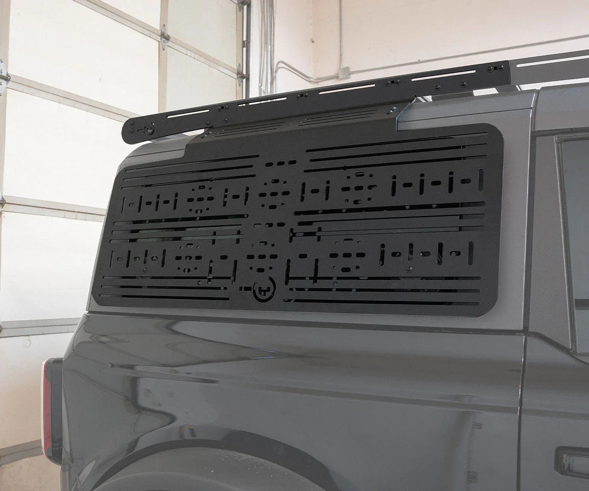 Black modular molle panel mounted on the rear window of a Ford Bronco overland SUV