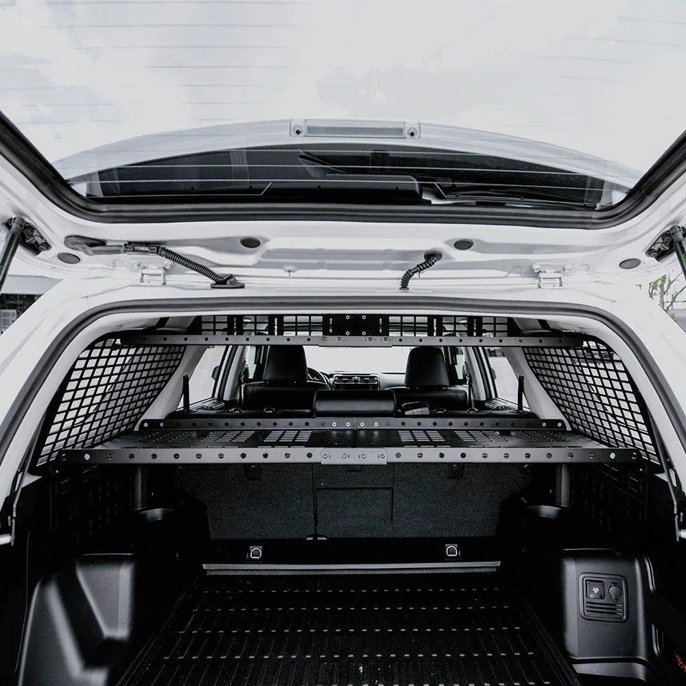 SUV cargo area with modular storage shelf and mesh panels for overlanding gear organization