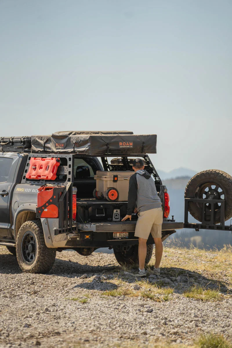 Toyota Tundra overland truck with swing arm rear tire carrier, adventure gear, rooftop tent