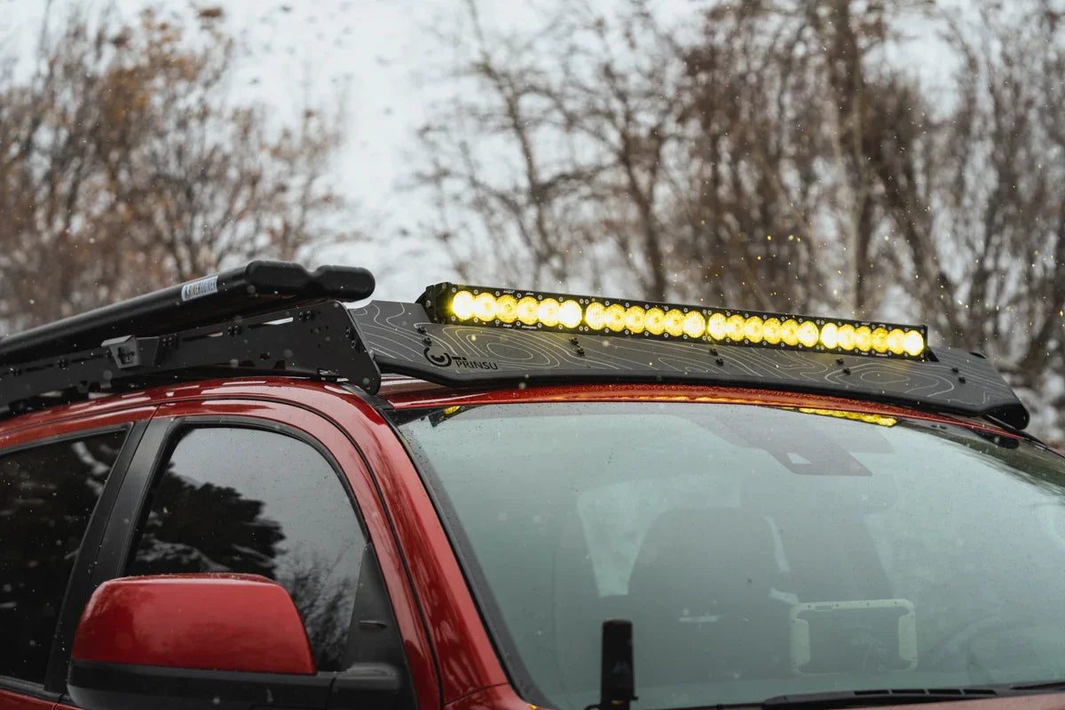 Toyota Tundra CrewMax with Prinsu roof rack and yellow LED light bar in winter setting
