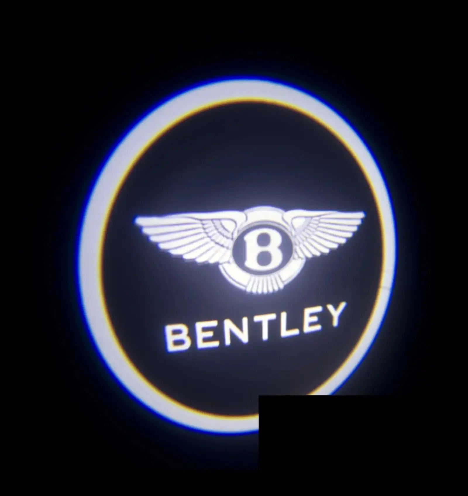 Illuminated Bentley logo car door projector with winged emblem on black background