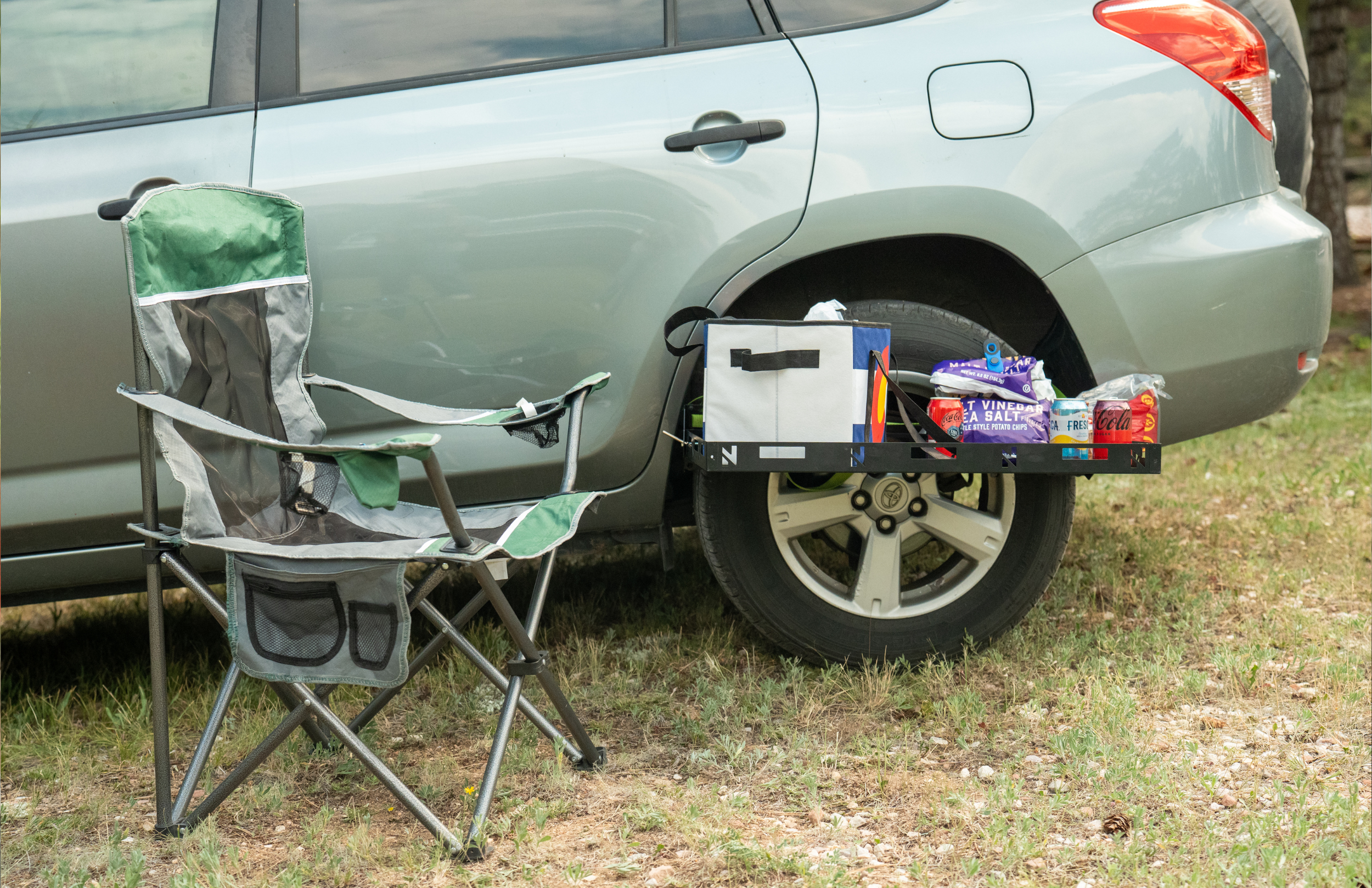 Nokhu Ledge made-in-USA steel camp table mounted to the side of an SUV at camp