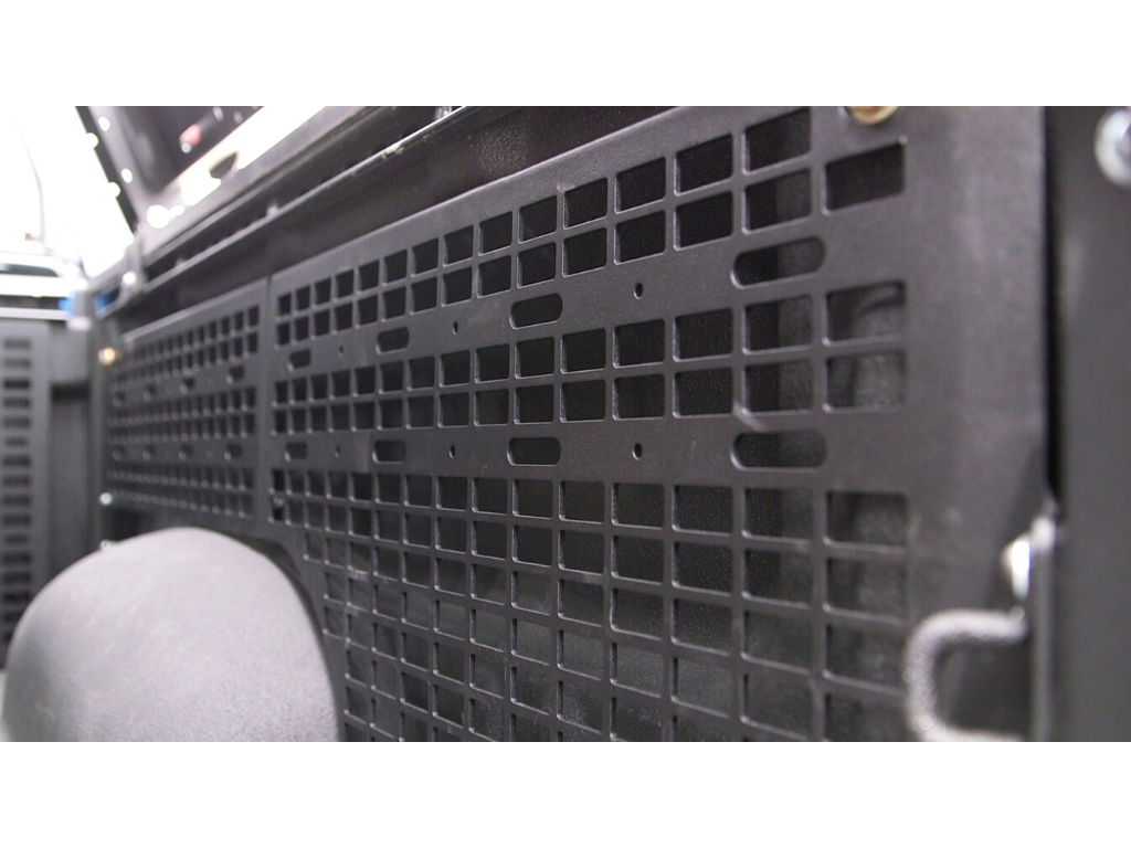 Close-up of black steel modular cargo panel in vehicle, overlanding storage accessory