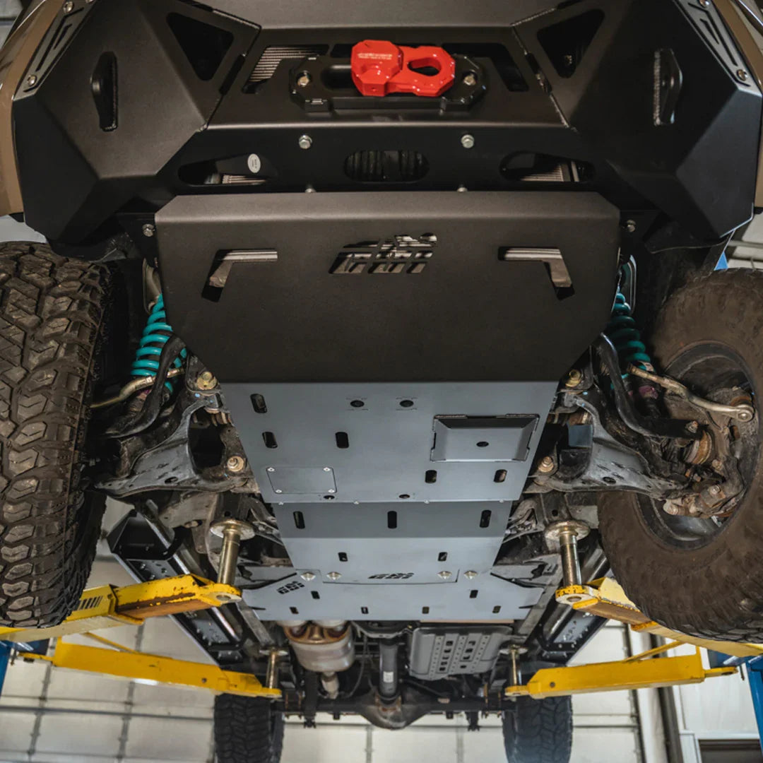 3rd gen Nissan Frontier full skid plate installed under vehicle, lifted for inspection