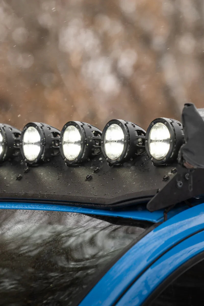 Close-up of LED off-road lights and wind deflector on blue Toyota Tacoma roof