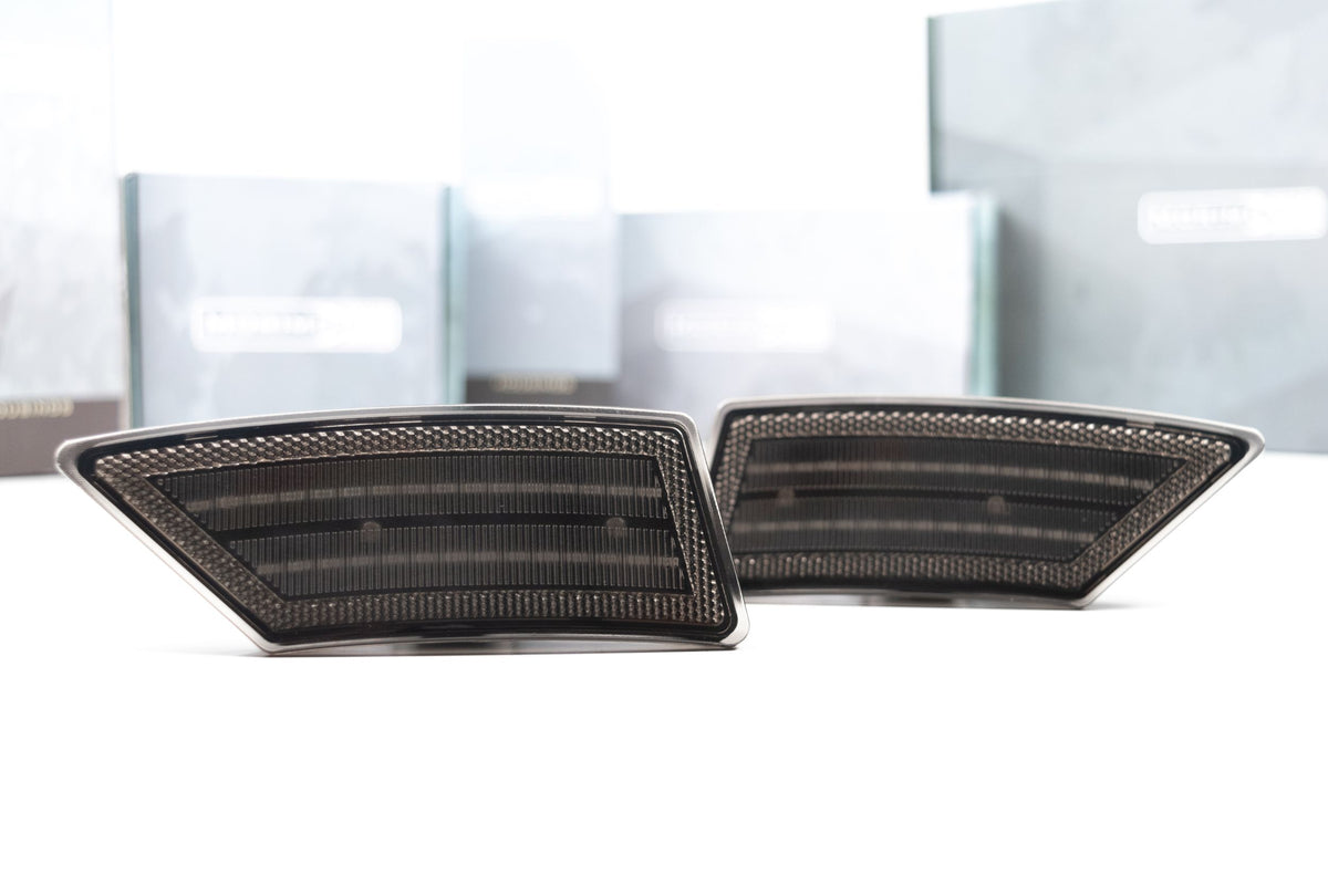 Pair of smoked Morimoto XB LED side markers for the 2019-2023 Ford Ranger, unlit, in front of retail boxes