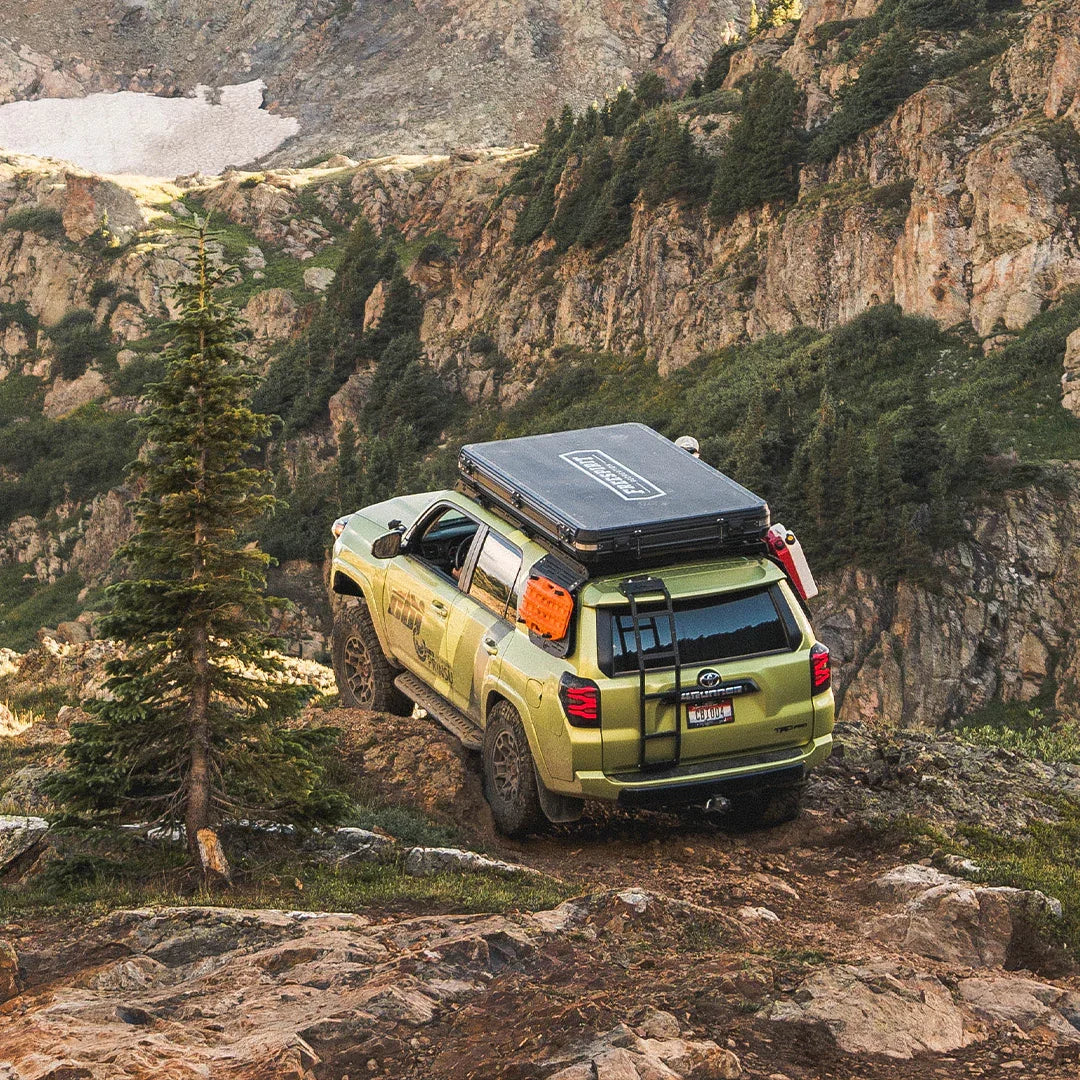 Toyota 4Runner with rooftop tent and overlanding gear on a mountain trail