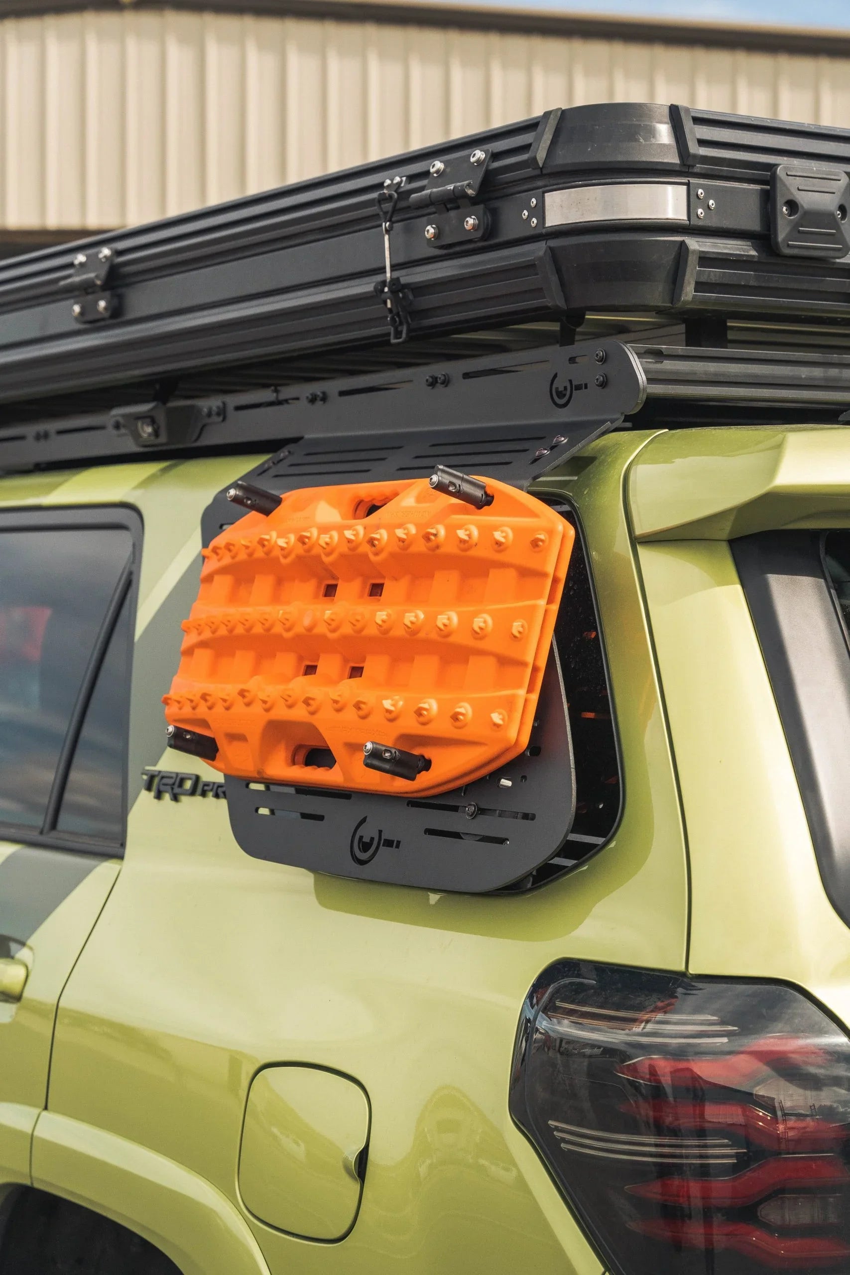Toyota 4Runner with rear window molle panel, roof rack, and mounted orange traction boards