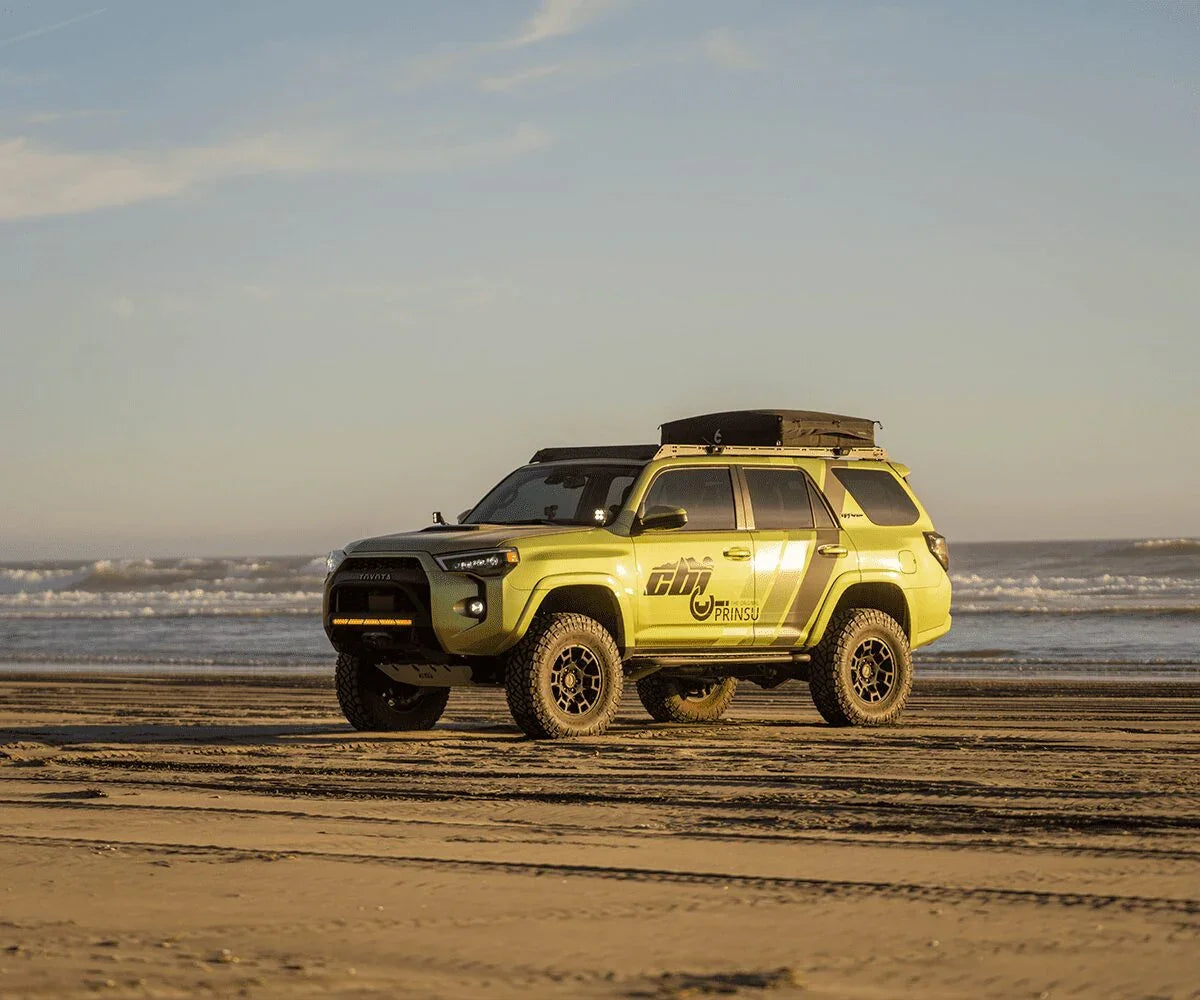 Toyota 4Runner overland build with rooftop tent and off-road accessories on sandy beach