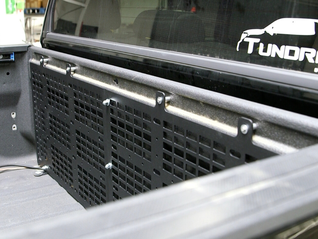 Toyota Tundra truck bed with mounted black steel MOLLE panel for overlanding gear