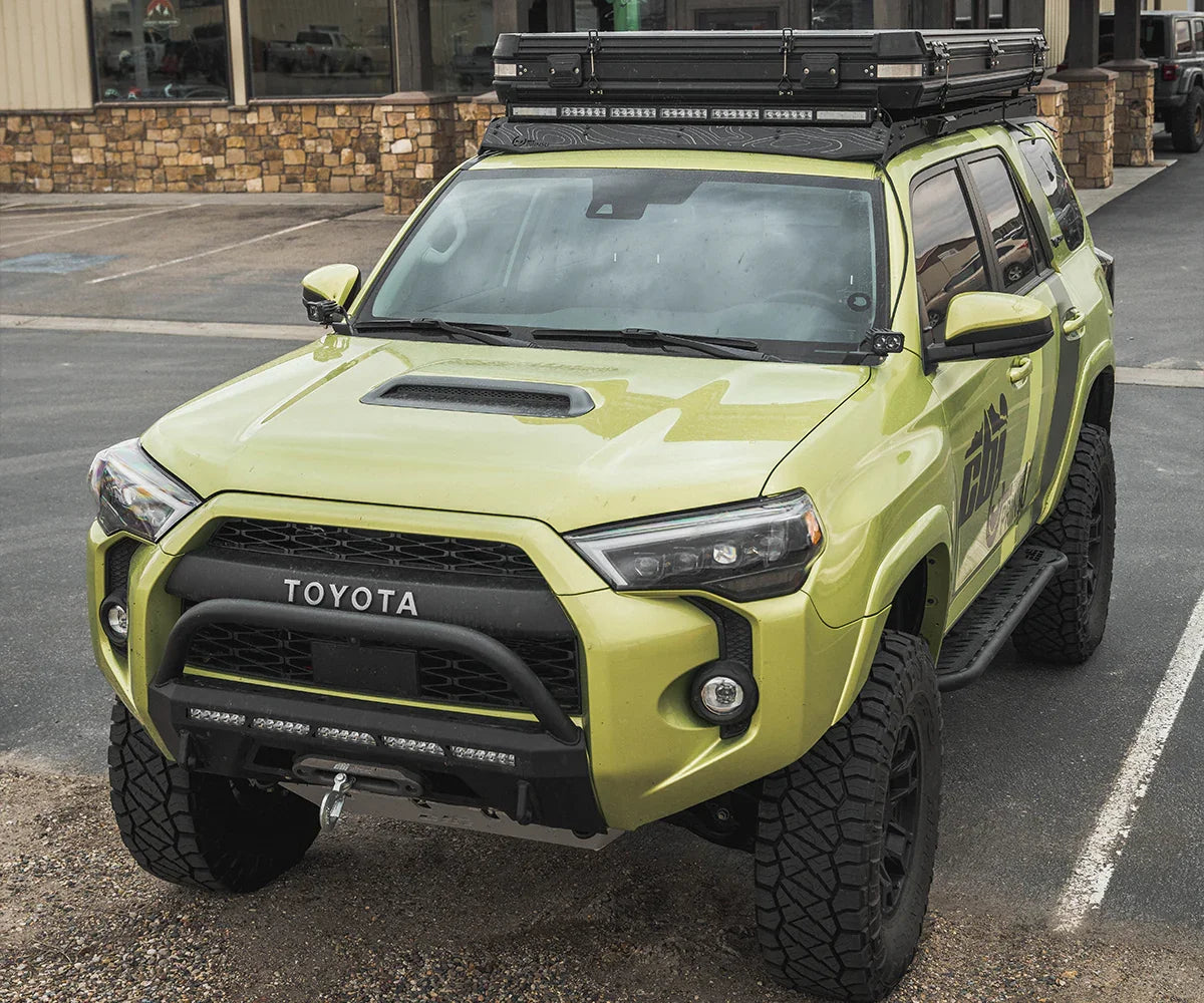 Toyota 4Runner with off-road tires, roof rack, and adventure camping gear accessories
