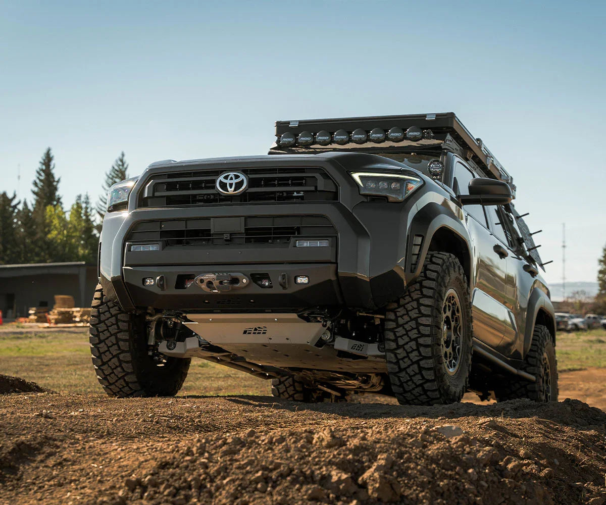 Lifted Toyota 4Runner with off-road tires, roof rack, and expedition gear on dirt terrain