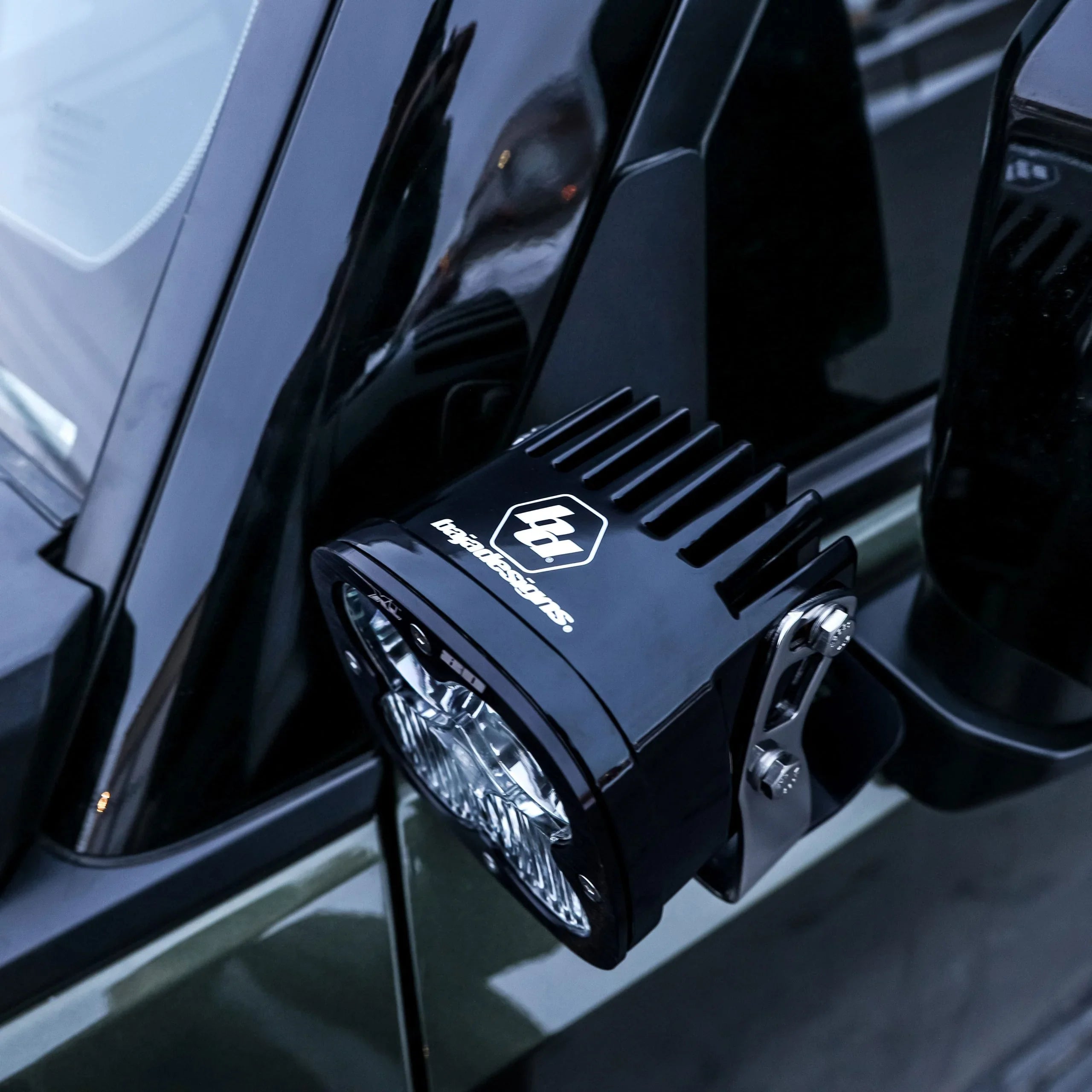 LED ditch light mounted on off-road vehicle mirror for overlanding