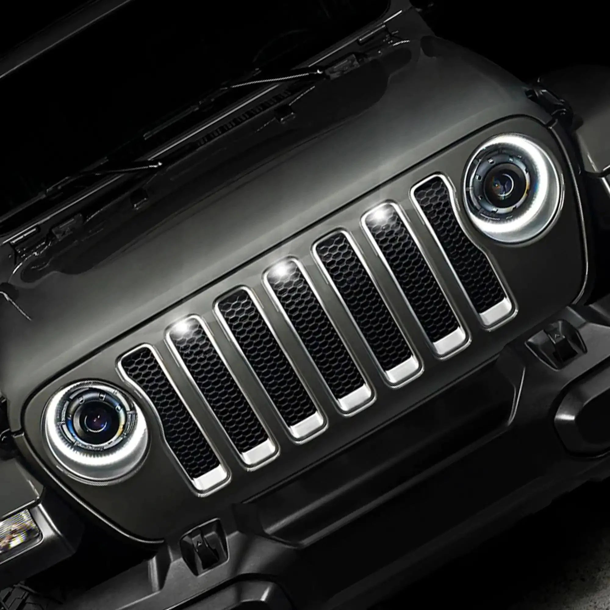 Front view of Jeep Wrangler grille and headlights, close-up, overlanding vehicle accessory