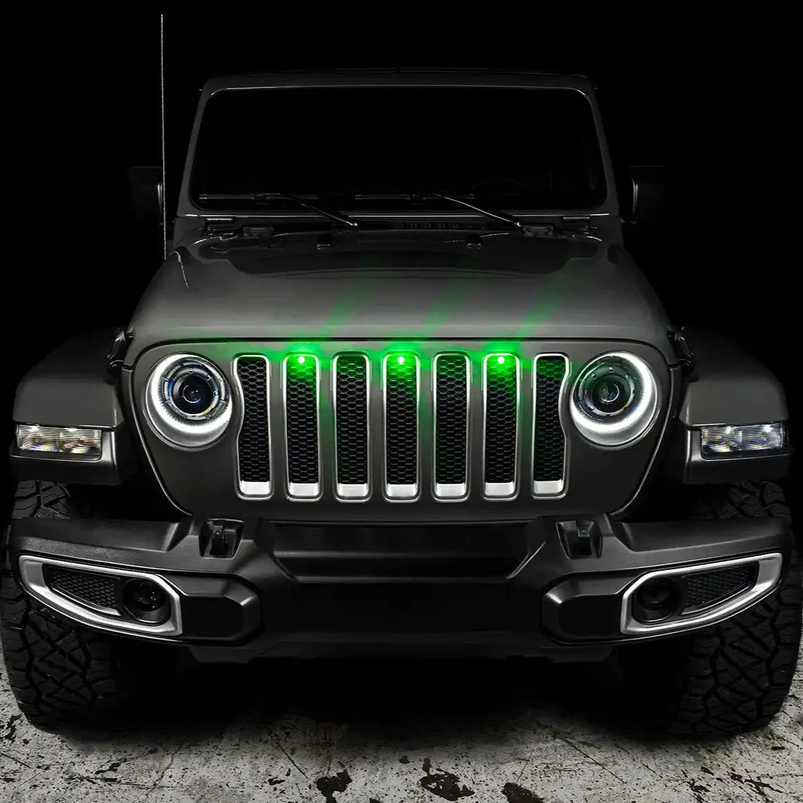 Front view of Jeep with aftermarket grille and green LED grill lights for off-road vehicles