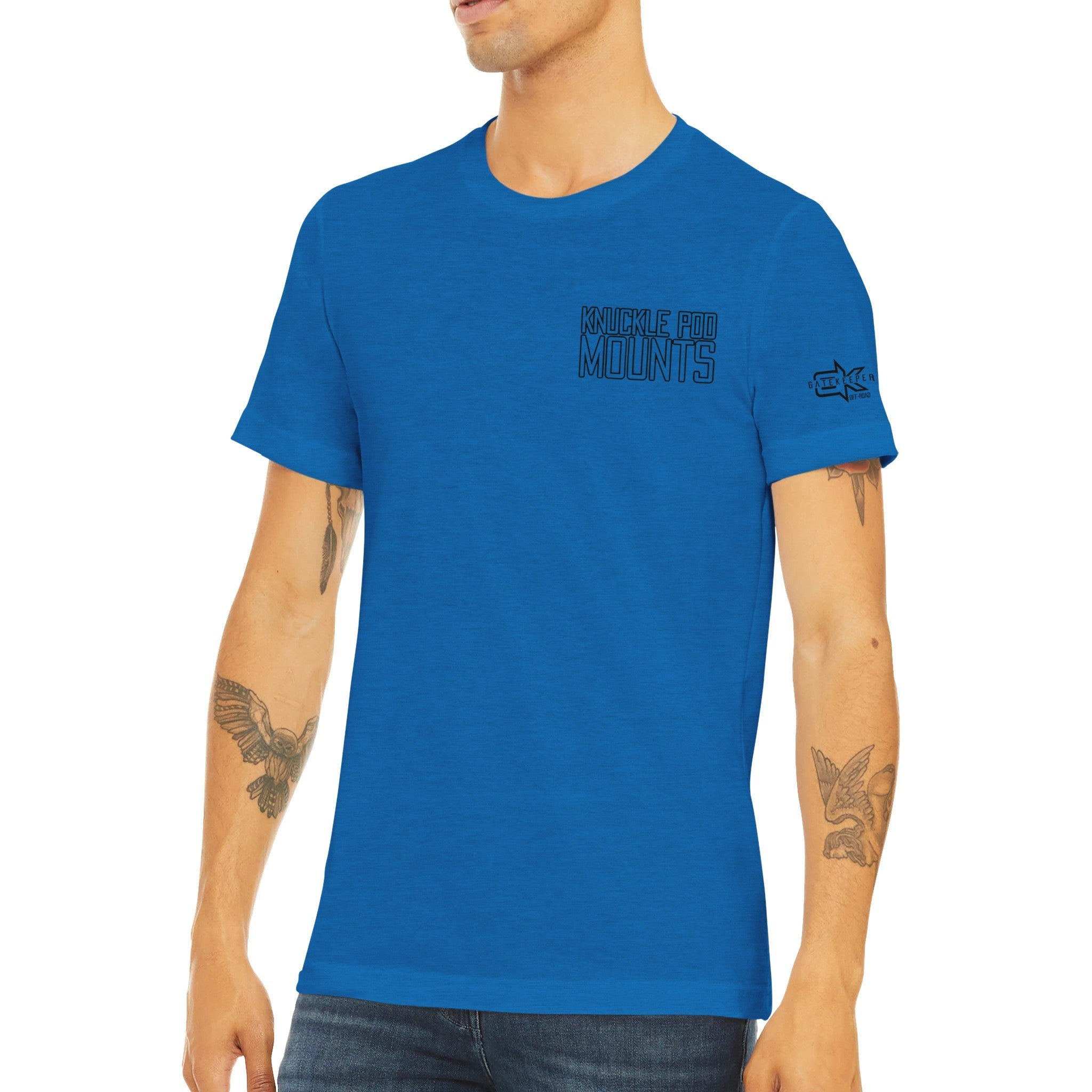 Man wearing blue Knuckle Pod Mounts t-shirt with tattoos, casual outdoor apparel