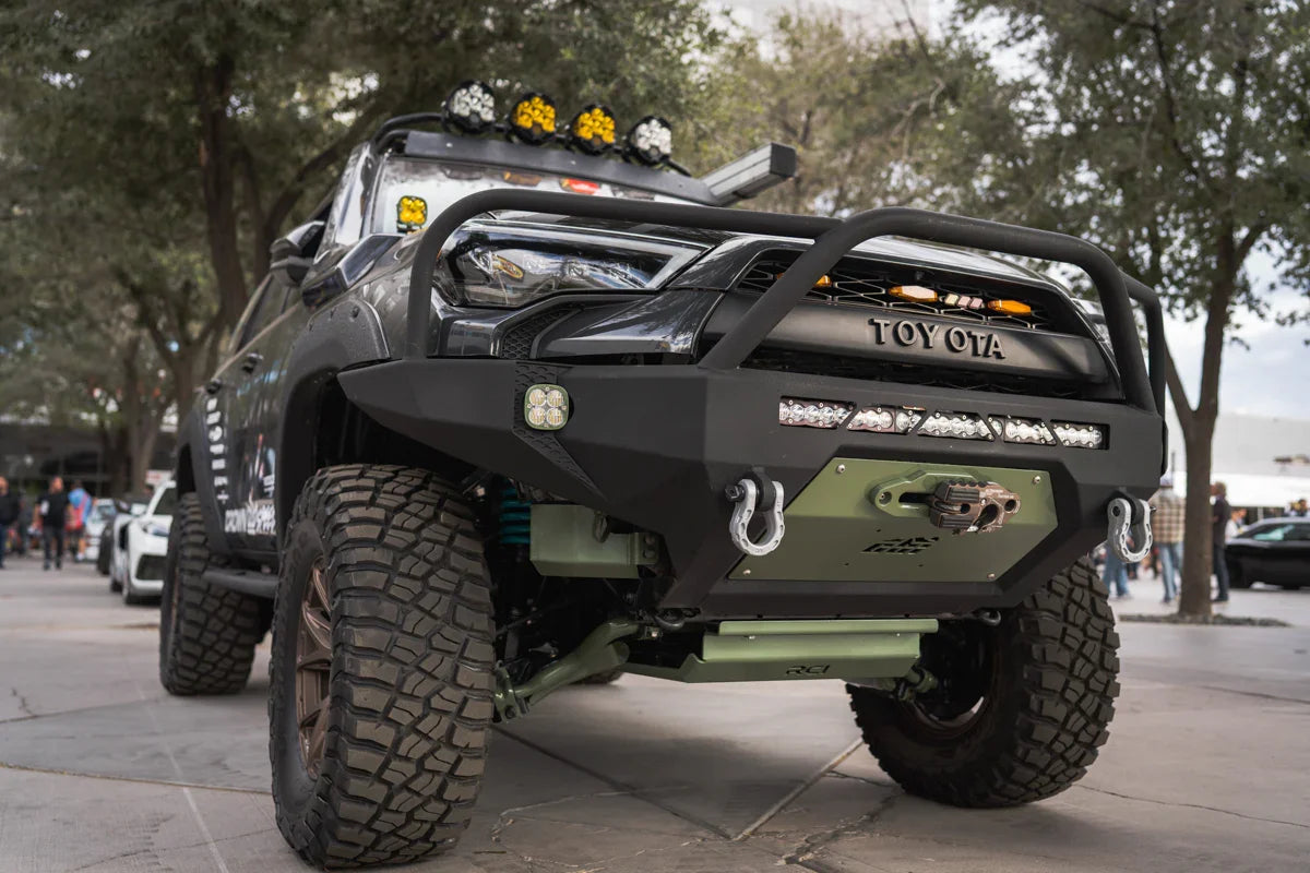 Lifted Toyota 4Runner with off-road bumper, winch, LED lights, and rugged tires outdoors