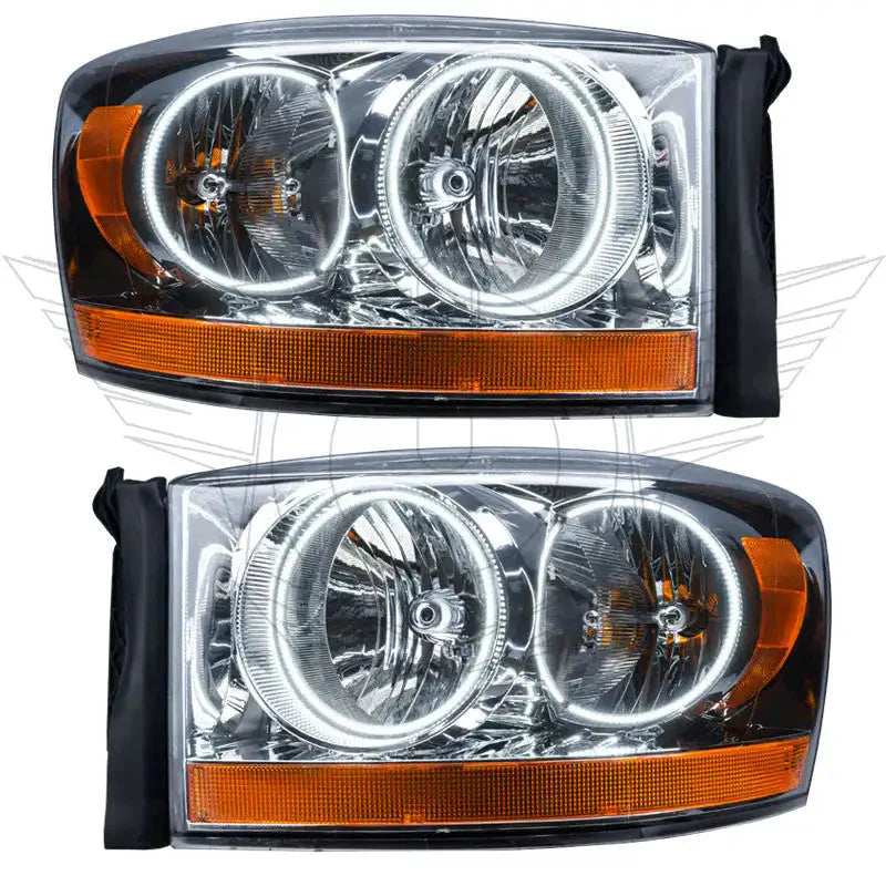 Pair of clear aftermarket truck headlights with orange reflectors and halo rings, ideal for Toyota Tundra or overlanding vehicles.