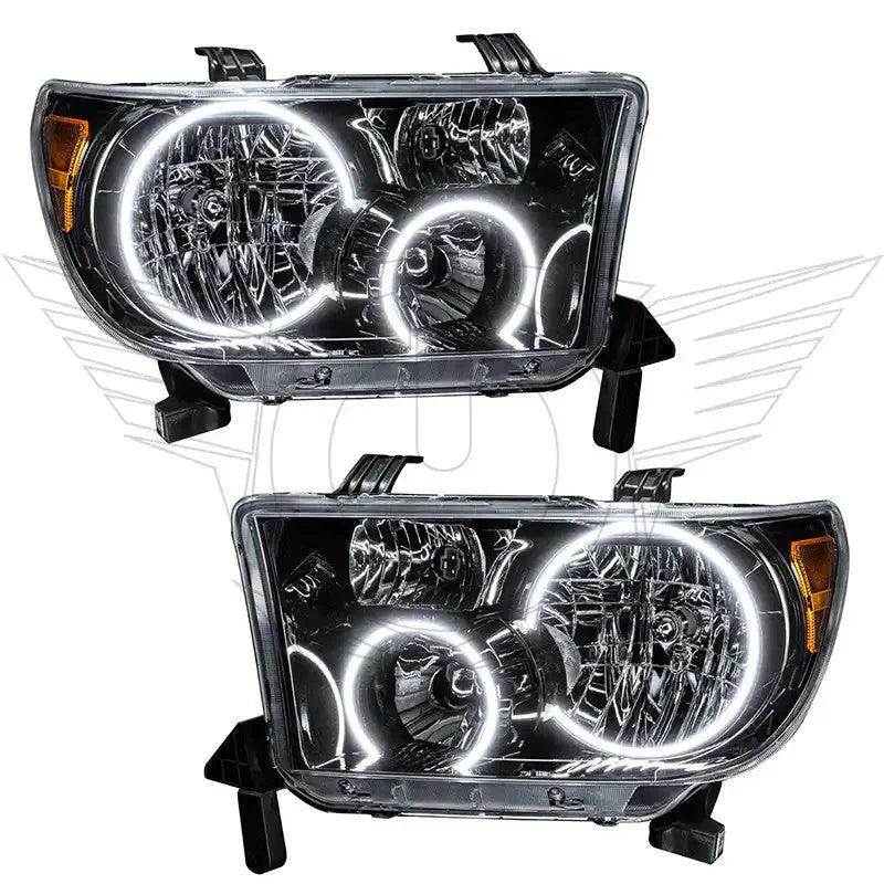 Pair of aftermarket LED halo projector headlights for Toyota Tacoma, clear lens, black housing