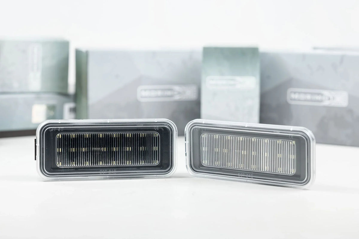 Pair of rectangular LED automotive lights with clear housings, displayed on a white surface