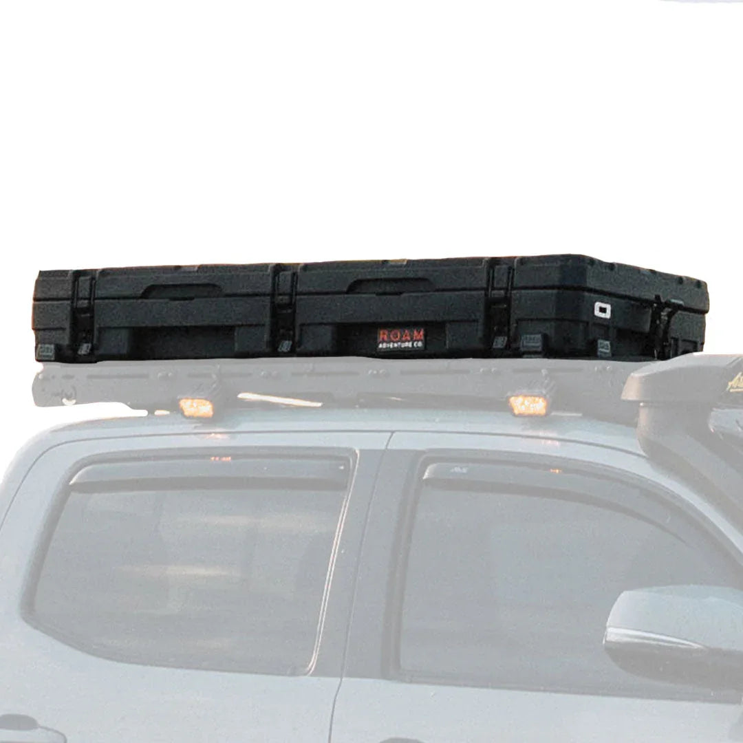 Black rooftop cargo case mounted on off-road vehicle roof rack for overlanding gear