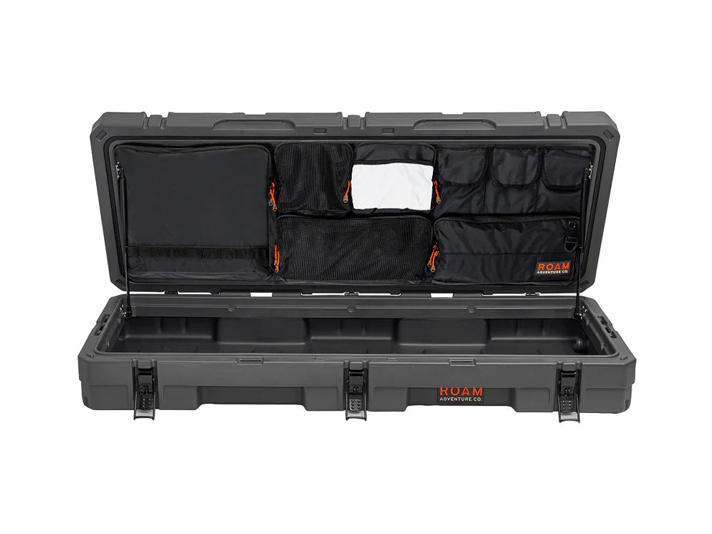 Rugged adventure gear storage case with open lid showing multiple organizer pockets