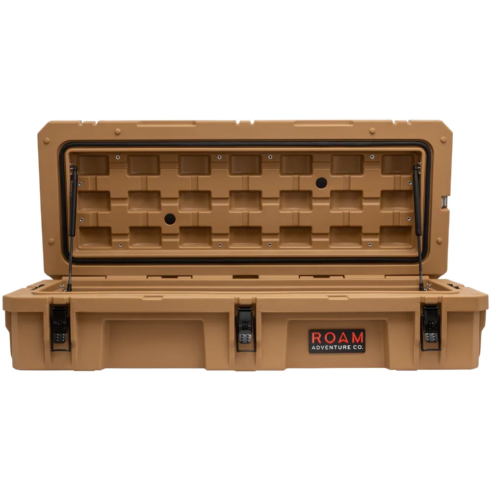Tan overland storage case with open lid, heavy-duty latches, and ROAM Adventure Co. logo