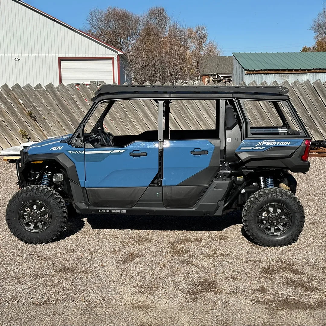 Blue Polaris Xpedition 5-seat off-road adventure vehicle parked outdoors