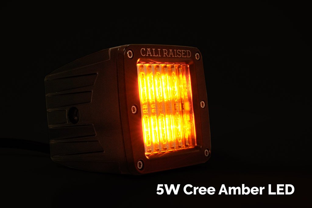Amber off-road LED pod light with bright 5W Cree LED, black housing, and engraved 'CALI RAISED' text.