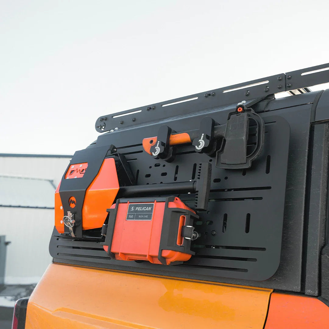 Ford Bronco accessory panel with mounted overlanding gear, axe, and storage box
