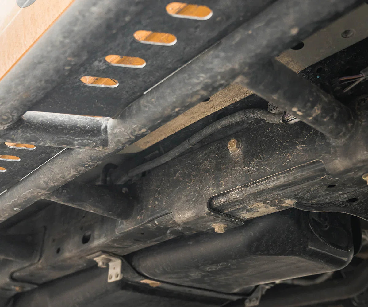Bolt-on steel rock slider installed under Ford Bronco, off-road vehicle protection