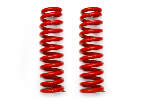 Pair of red suspension coil springs for off-road vehicles on white background