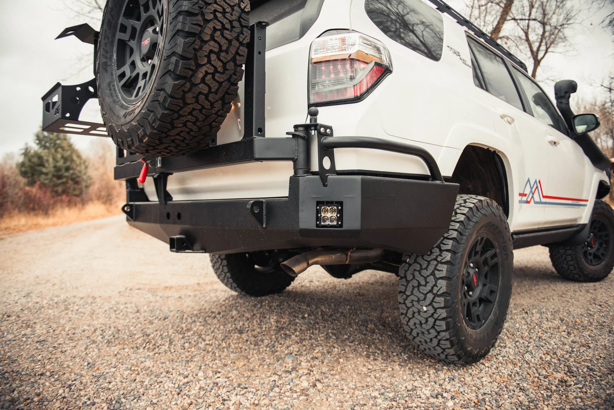 Toyota 4Runner with swing arm rear bumper, off-road tires, and spare tire carrier