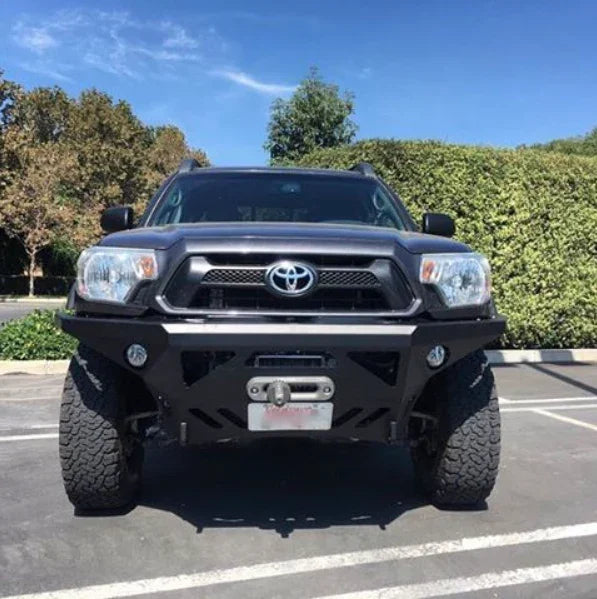Toyota Tacoma with black off-road front bumper and winch in parking lot