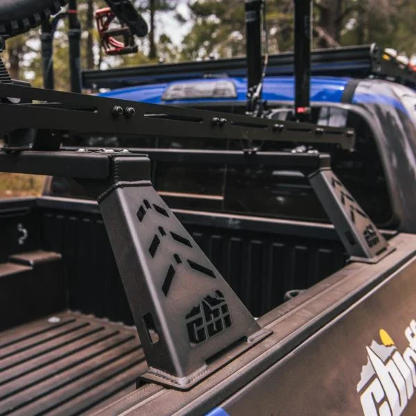 Overland bed bars installed in a Toyota Tacoma truck bed, outdoor setting
