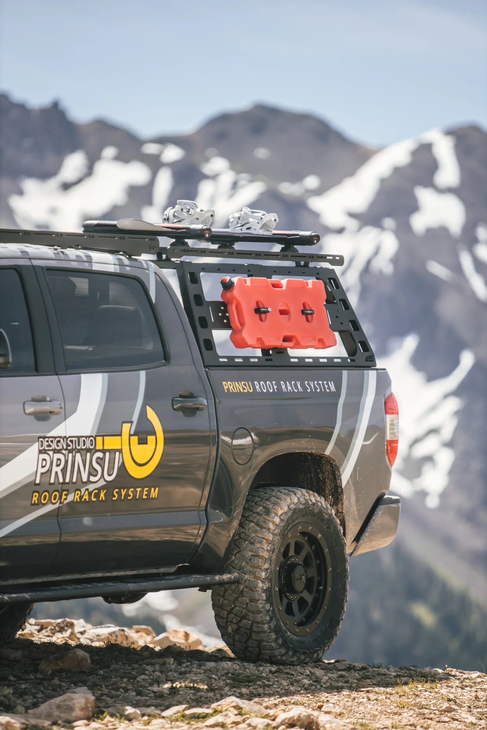 Toyota Tundra with bed rack and roof rack system, carrying gear in a mountain setting