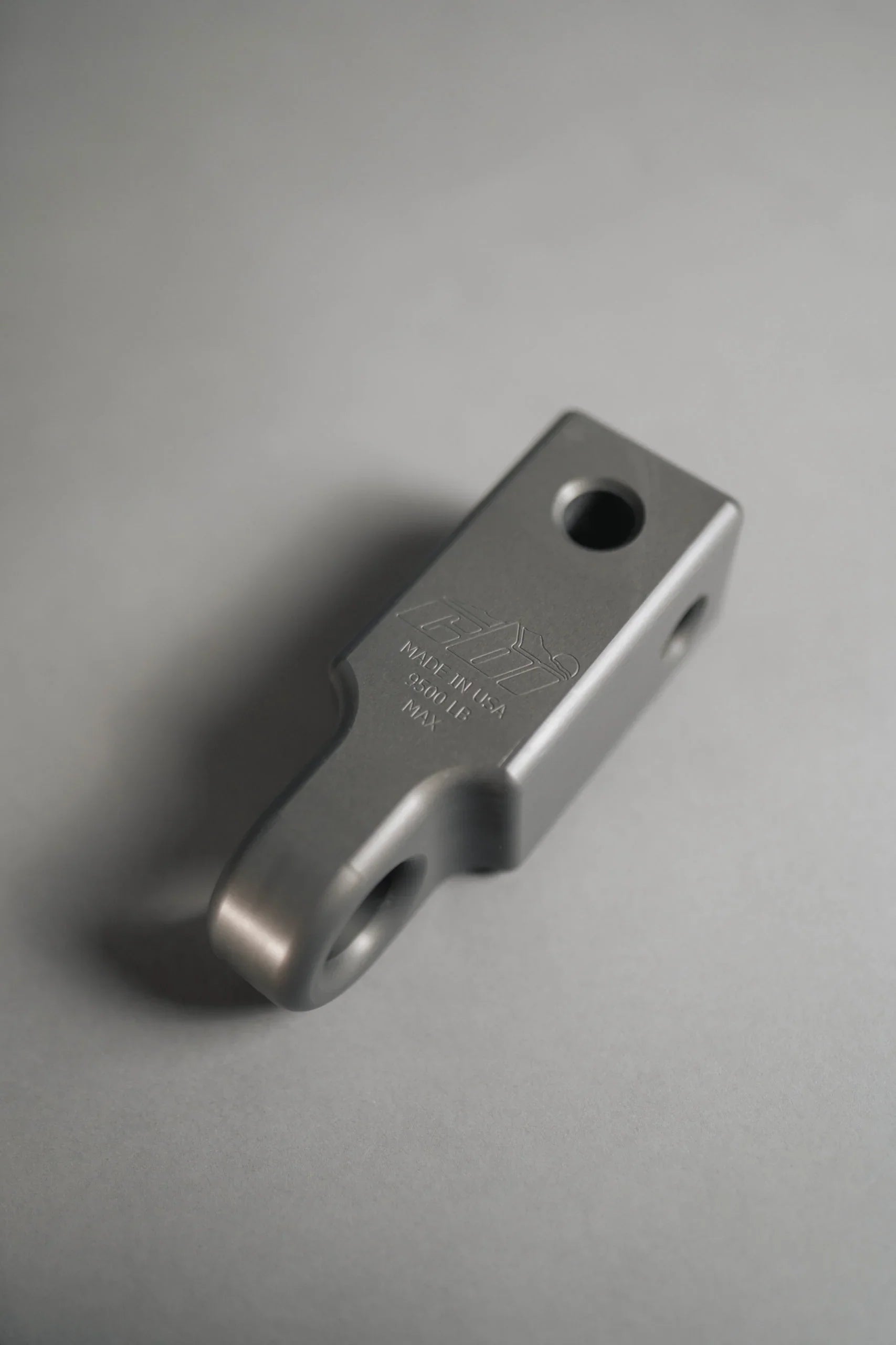 Gray steel receiver recovery point with engraved weight rating, for off-road vehicles