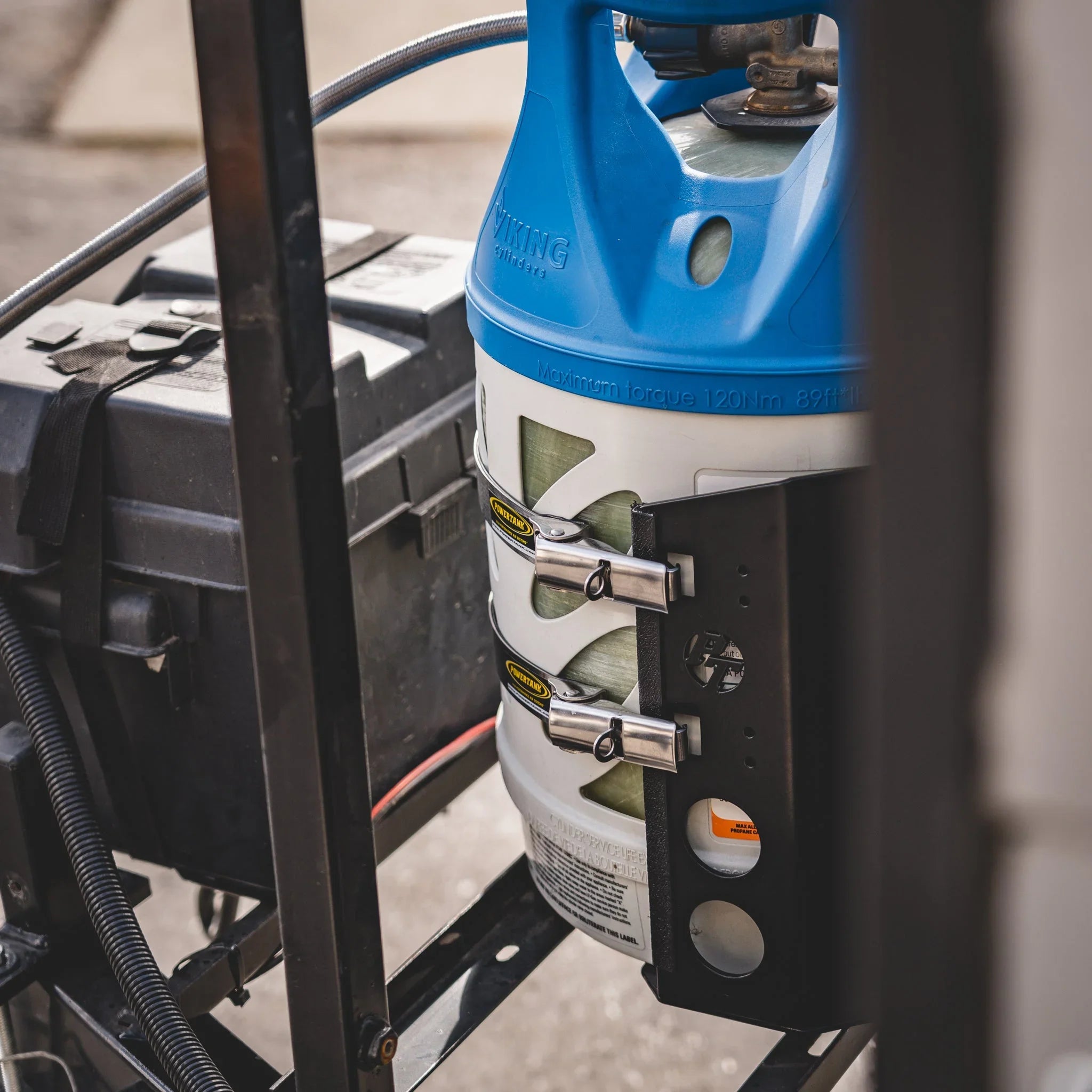 Propane tank secured with steel mounting brackets on overland vehicle rack