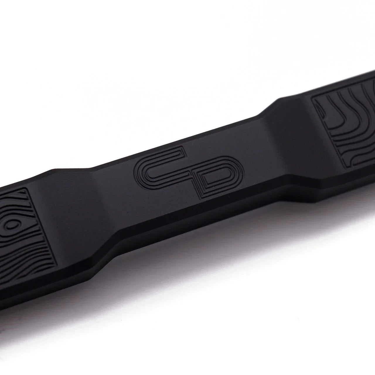 Black aluminum battery tie down with engraved pattern for Toyota or Lexus vehicles