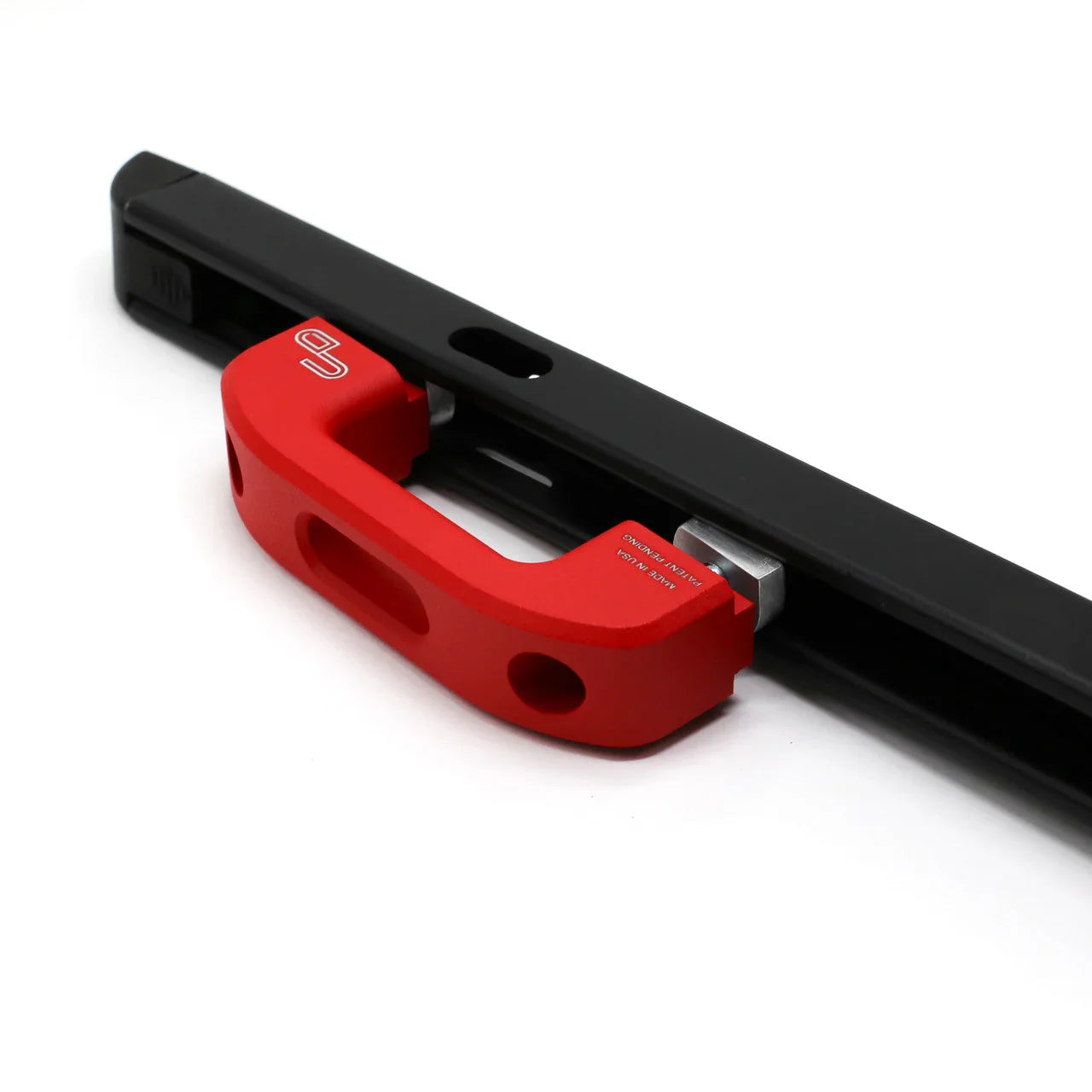 Red aluminum rail T-nut mounted on black metal track for overland vehicle accessories