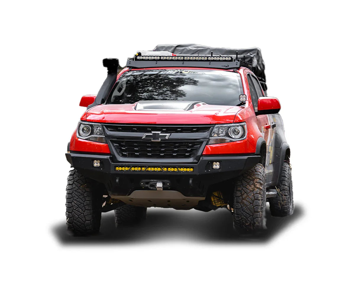 Red Chevrolet Colorado off-road truck with overlanding gear, lifted tires, and roof rack