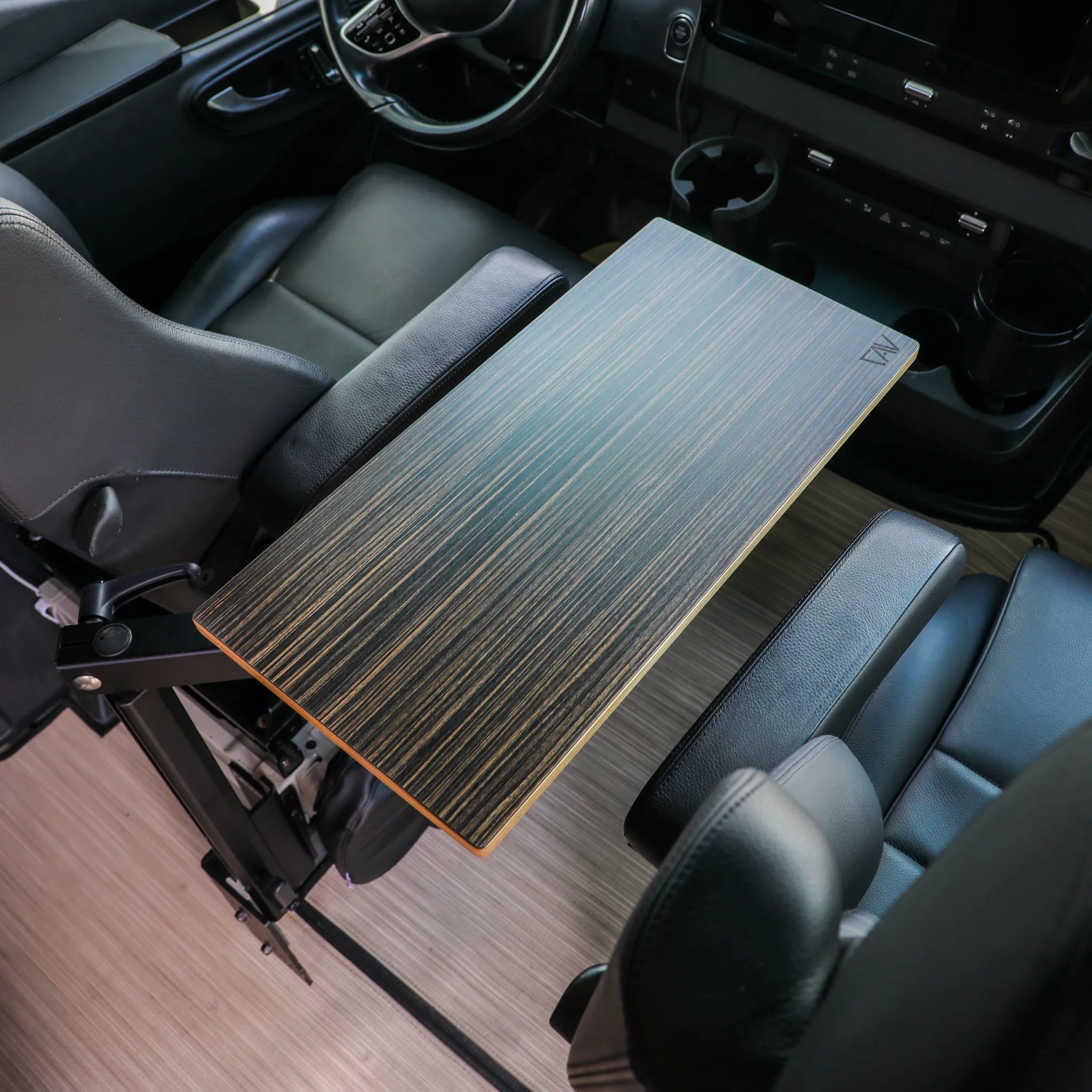 Vehicle interior with a mounted wood grain center console table between two front seats