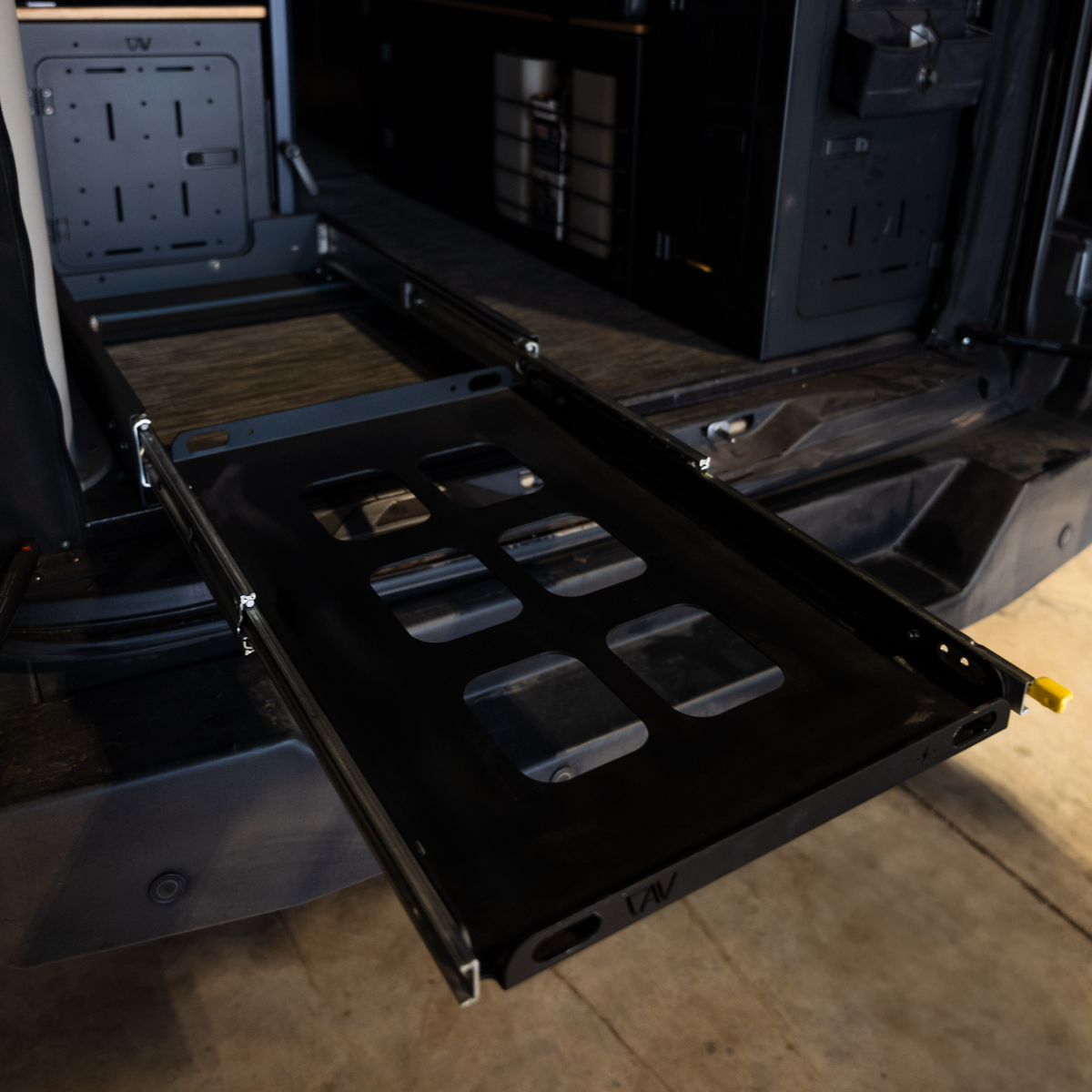 Heavy-duty metal cargo slide installed in an off-road vehicle interior, ideal for overlanding.